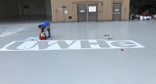 Kris Head Installing Vinyl for Helicopter pad